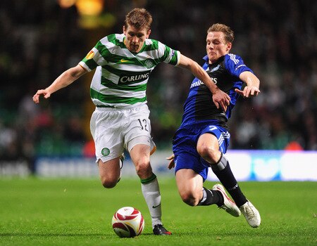 GLASGOW, SCOTLAND - OCTOBER 22:  Mark Wilson of Celtic is tackled by Marcell Jansen of Hamburg SV during the UEFA Europa League Group C match between Celtic and Hamburg SV at Celtic Park on October 22, 2009 in Glasgow, Scotland.  <br /><br /><span class="help">(Photo by Mike Hewitt/Bongarts/Getty Images)</span>