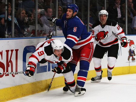 NEW YORK, NY - OCTOBER 22:  Zach Parise #9 of the New Jersey Devils is checked by Dan Girardi #5 of the New York Rangers  during their game on October 22, 2009 at Madison Square Garden in New York City, New York.  <br /><br /><span class="help">(Photo by Al Bello/Getty Images)</span>