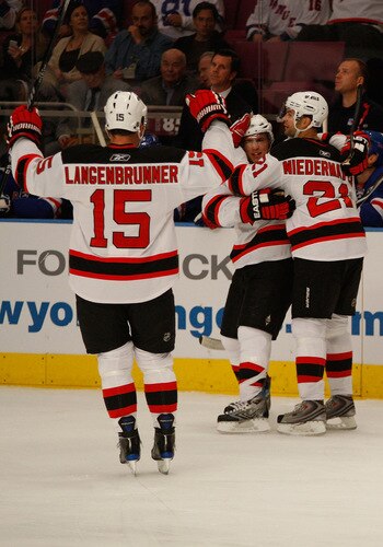 NEW YORK - OCTOBER 22: Jamie Langenbrunner #15 and Rob Niedermayer #21 of the New Jersey Devils celebrate with teammate Zach Parise #9 after he scored in the first period against the New York Rangers during the game on October 22, 2009 at Madison Square Garden in New York City. <br /><br /><span class="help">(Photo by Jared Wickerham/Getty Images)</span>