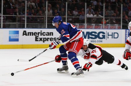 NEW YORK, NY - OCTOBER 22:  Artem Anisimov #42 of the New York Rangers skates with the puck as Bryce Salvador #24 of the New Jersey Devils defends during their game on October 22, 2009 at Madison Square Garden in New York City, New York.  <br /><br /><span class="help">(Photo by Al Bello/Getty Images)</span>