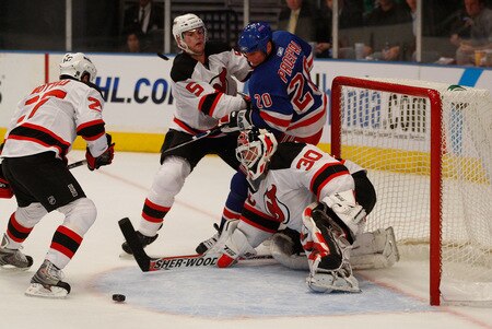 NEW YORK - OCTOBER 22: Vinny Prospal #20 of the New York Rangers fights for the puck near the crease in front of Zach Parise #9 and Martin Brodeur #30 of the New Jersey Devils during the game on October 22, 2009 at Madison Square Garden in New York City. <br /><br /><span class="help">(Photo by Jared Wickerham/Getty Images)</span>