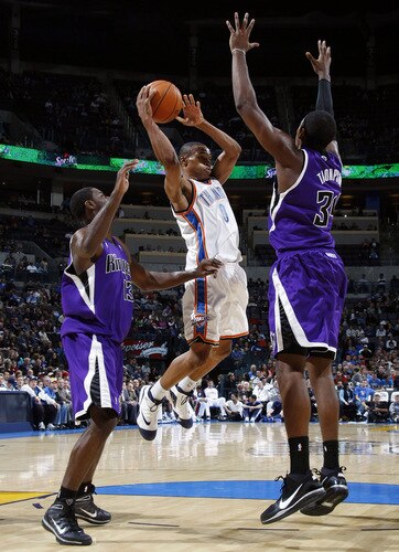 OKLAHOMA CITY - OCTOBER 22:  Russell Westbrook #0 of the Oklahoma City Thunder attempts to pass the ball against Tyreke Evans #13 and Jason Thompson #34 of the Sacremento Kings on October 22, 2009 at the Ford Center in Oklahoma City, Oklahoma. <br /><br /><span class="help">(Photo by Layne Murdoch/NBAE via Getty Images)</span>