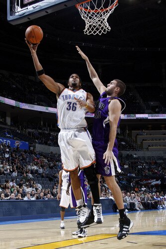 OKLAHOMA CITY - OCTOBER 22:  Etan Thomas #36 of the Oklahoma City Thunder goes to the basket against Spencer Hawes #31 of the Sacremento Kings on October 22, 2009 at the Ford Center in Oklahoma City, Oklahoma. <br /><br /><span class="help">(Photo by Layne Murdoch/NBAE via Getty Images)</span>