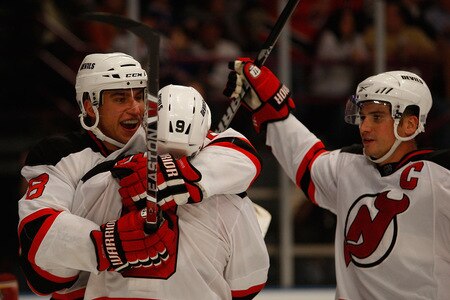 NEW YORK - OCTOBER 22: Dainius Zubrus #8 of the New Jersey Devils celebrates with teammates Zach Parise #9 and Jamie Langenbrunner #15 after Zubrus scored a goal in third period against the New York Rangers on October 22, 2009 at Madison Square Garden in New York City. <br /><br /><span class="help">(Photo by Jared Wickerham/Getty Images)</span>