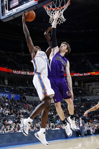 OKLAHOMA CITY - OCTOBER 22:  Serge Ibaka #9 of the Oklahoma City Thunder slam dunks the ball on Andres Nocioni #5 of the Sacremento Kings on October 22, 2009 at the Ford Center in Oklahoma City, Oklahoma. <br /><br /><span class="help">(Photo by Layne Murdoch/NBAE via Getty Images)</span>