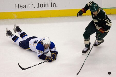 ST. LOUIS, MO. - OCTOBER 23: Kyle Brodziak #21 of the Minnesota Wild looks to keep the puck away from TJ Oshi #74 of the St. Louis Blues at the Scottrade Center on October 23, 2009 in St. Louis, Missouri.  <br /><br /><span class="help">(Photo by Dilip Vishwanat/Getty Images)</span>