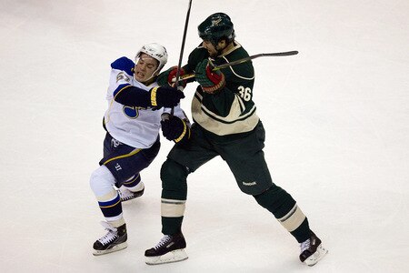 ST. LOUIS, MO. - OCTOBER 23: John Scott #36 of the Minnesota Wild poke checks David Perron #57 of the St. Louis Blues at the Scottrade Center on October 23, 2009 in St. Louis, Missouri.  <br /><br /><span class="help">(Photo by Dilip Vishwanat/Getty Images)</span>