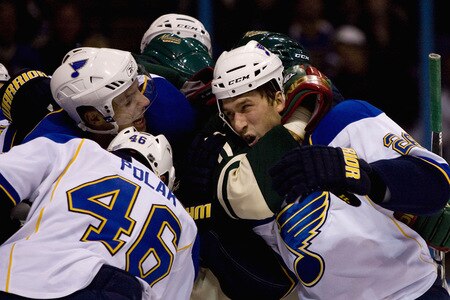 ST. LOUIS, MO. - OCTOBER 23: BJ Crombeen #26 of the St. Louis Blues is caught in a headlock against the Minnesota Wild at the Scottrade Center on October 23, 2009 in St. Louis, Missouri.  <br /><br /><span class="help">(Photo by Dilip Vishwanat/Getty Images)</span>