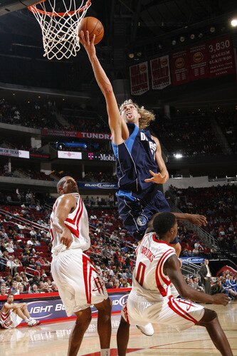 HOUSTON - OCTOBER 23:  Dirk Nowitzki #41 of the Dallas Mavericks shoots the ball over Aaron Brooks #0 and Shane Battier #31 of the Houston Rockets on October 23, 2009 at the Toyota Center in Houston, Texas. <br /><br /><span class="help">(Photo by Bill Baptist/NBAE via Getty Images)</span>