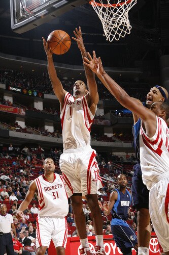 HOUSTON - OCTOBER 23:  Trevor Ariza #1 of the Houston Rockets rebounds the ball against the Dallas Mavericks on October 23, 2009 at the Toyota Center in Houston, Texas. <br /><br /><span class="help">(Photo by Bill Baptist/NBAE via Getty Images)</span>
