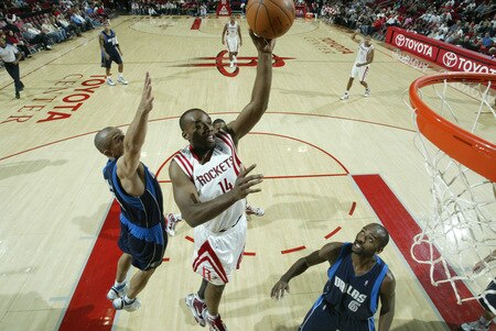 HOUSTON - OCTOBER 23:  Carl Landry #16 of the Houston Rockets shoots the ball over Jason Kidd #2 and Quinton Ross #6 of the Dallas Mavericks on October 23, 2009 at the Toyota Center in Houston, Texas. <br /><br /><span class="help">(Photo by Bill Baptist/NBAE via Getty Images)</span>