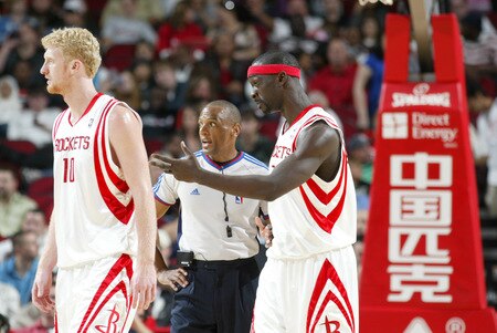 HOUSTON - OCTOBER 23:  Pops Mensah-Bonsu #21 of the Houston Rockets discusses the NBA officials call on him and Drew Gooden #90 of the Dallas Mavericks with Karl Lane #128 NBA official on October 23, 2009 at the Toyota Center in Houston, Texas. <br /><br /><span class="help">(Photo by Bill Baptist/NBAE via Getty Images)</span>