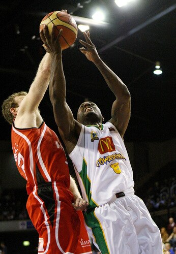 WOLLONGONG, AUSTRALIA - OCTOBER 24:  Corey Williams of Townsville and Mat Campbell of the Hawks contest possession during the round five NBL match between the Wollongong Hawks and the Townsville Crocodiles at Wollongong Entertainment Centre on October 24, 2009 in Wollongong, Australia.  <br /><br /><span class="help">(Photo by Mark Nolan/Getty Images)</span>