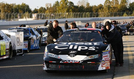 MEMPHIS, TN - OCTOBER 24:  The crew of Jason Leffler pushes his #38 Great Clips Toyota onto the grid during qualifying for the NASCAR Nationwide series Kroger 'On Track For Cure' 250 race at the Memphis Motorsports Park on October 24, 2009 in Memphis, Tennessee.  <br /><br /><span class="help">(Photo by John Sommers II/Getty Images)</span>