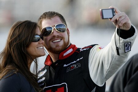 MEMPHIS, TN - OCTOBER 24:   Robert Richardson Jr. , driver of the #23 Mahindra takes a picture with a fan on the grid during qualifying for the NASCAR Nationwide series Kroger 'On Track For  Cure' 250 race at the Memphis Motorsports Park on October 24, 2009 in Memphis, Tennessee.  <br /><br /><span class="help">(Photo by John Sommers II/Getty Images)</span>