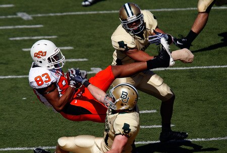 WACO, TX - OCTOBER 24:  Wide receiver Dameron Fooks #83 of the Oklahoma State Cowboys makes a touchdown pass reception against Tim Atchison #8 and Jordan Lake #21 of the Baylor Bears at Floyd Casey Stadium on October 24, 2009 in Waco, Texas.  <br /><br /><span class="help">(Photo by Ronald Martinez/Getty Images)</span>