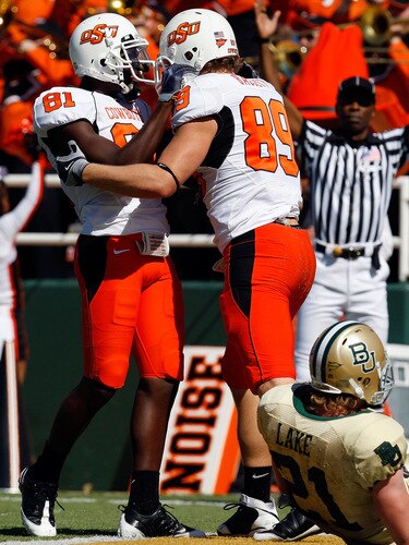 WACO, TX - OCTOBER 24:  Justin Blackmon #81 and Cooper Nicholas #89 of the Oklahoma State Cowboys celebrate a touchdown in front of Jordan Lake #21 of the Baylor Bears at Floyd Casey Stadium on October 24, 2009 in Waco, Texas.  <br /><br /><span class="help">(Photo by Ronald Martinez/Getty Images)</span>