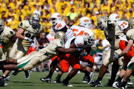WACO, TX - OCTOBER 24:  Running back Beau Johnson #2 of the Oklahoma State Cowboys runs the ball past Earl Patin #1 of the Baylor Bears at Floyd Casey Stadium on October 24, 2009 in Waco, Texas.  <br /><br /><span class="help">(Photo by Ronald Martinez/Getty Images)</span>