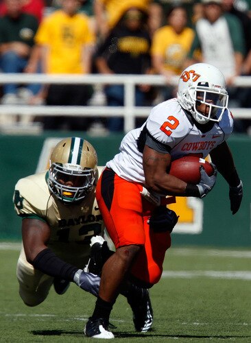 WACO, TX - OCTOBER 24:  Running back Beau Johnson #2 of the Oklahoma State Cowboys runs the ball past Tracy Robertson #13 of the Baylor Bears at Floyd Casey Stadium on October 24, 2009 in Waco, Texas.  <br /><br /><span class="help">(Photo by Ronald Martinez/Getty Images)</span>