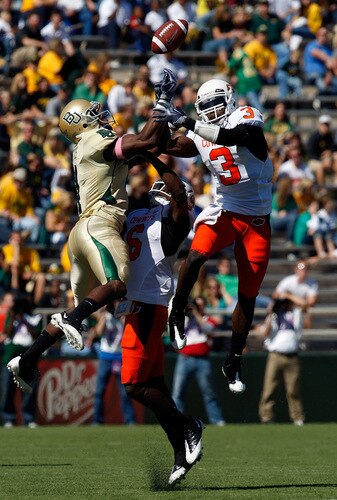 WACO, TX - OCTOBER 24:  Wide receiver David Gettis #4 of the Baylor Bears jumps for a pass against Andrew McGee #6 and Victor Johnson #3 of the Oklahoma State Cowboys at Floyd Casey Stadium on October 24, 2009 in Waco, Texas.  <br /><br /><span class="help">(Photo by Ronald Martinez/Getty Images)</span>