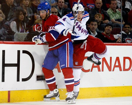 MONTREAL- OCTOBER 24: Michael Del Zotto #4 of the New York Rangers body checks Matt D'Agostini #36 of the Montreal Canadiens during the NHL game on October 24, 2009 at the Bell Centre in Montreal, Quebec, Canada. <br /><br /><span class="help">(Photo by Richard Wolowicz/Getty Images)</span>