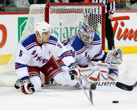 MONTREAL- OCTOBER 24: Daniel Girardi #5 gets down to lcear the puck from in front of Henrik Lundqvist #30 of the New York Rangers during the NHL game against the Montreal Canadiens on October 24, 2009 at the Bell Centre in Montreal, Quebec, Canada. <br /><br /><span class="help">(Photo by Richard Wolowicz/Getty Images)</span>