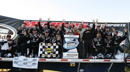MEMPHIS, TN - OCTOBER 24:  Brad Keselowski, driver of the #88 Delphi Chevrolet celebrates winning the the NASCAR Nationwide series Kroger 'On Track For Cure' 250 race with his team at the Memphis Motorsports Park on October 24, 2009 in Memphis, Tennessee.  <br /><br /><span class="help">(Photo by John Sommers II/Getty Images)</span>