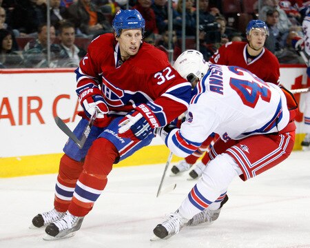 MONTREAL- OCTOBER 24: Artem Anisimov #42 of the New York Rangers and Travis Moen #32 of the Montreal Canadiens collide during the NHL game on October 24, 2009 at the Bell Centre in Montreal, Quebec, Canada. <br /><br /><span class="help">(Photo by Richard Wolowicz/Getty Images)</span>