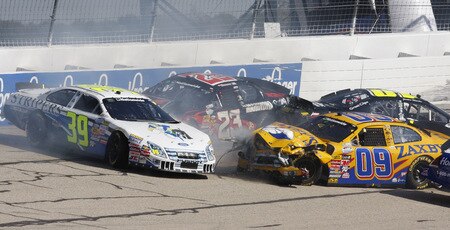 MEMPHIS, TN - OCTOBER 24:   Eddie MacDonald, driver of the #39 Go Green Racing Ford, Robert Richards Jr., driver of the #23 Mahindra Chevrolet, John Wes Townley, driver of the #09 Zaxby's Ford and Justin Marks, driver of the #10 Construct Corps Toyota wreck in the first turn during the NASCAR Nationwide series Kroger 'On Track For  Cure' 250 race at the Memphis Motorsports Park on October 24, 2009 in Memphis, Tennessee.  <br /><br /><span class="help">(Photo by John Sommers II/Getty Images)</span>