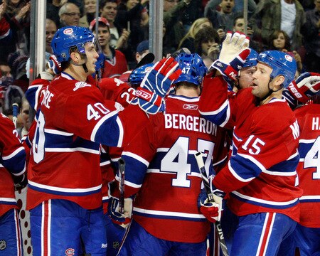 MONTREAL- OCTOBER 24: Maxim Lapierre #40 and Glen Metropolit #15 of the Montreal Canadiens celebrate the overtime goal from Mike Cammalleri #13 during the NHL game against the New York Rangers on October 24, 2009 at the Bell Centre in Montreal, Quebec, Canada. <br /><br /><span class="help">(Photo by Richard Wolowicz/Getty Images)</span>