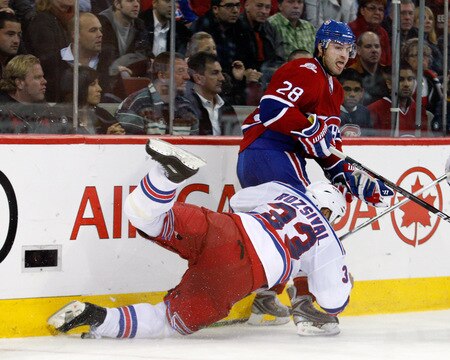 MONTREAL- OCTOBER 24: Kyle Chipchura #28 of the Montreal Canadiens body checks Michal Rozsival #33 of the New York Rangers during the NHL game on October 24, 2009 at the Bell Centre in Montreal, Quebec, Canada. <br /><br /><span class="help">(Photo by Richard Wolowicz/Getty Images)</span>