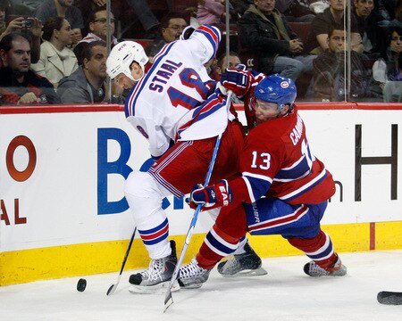 MONTREAL- OCTOBER 24: Mike Cammalleri #13 of the Montreal Canadiens and Marc Staal #18 of the New York Rangers battle for the puck during the NHL game on October 24, 2009 at the Bell Centre in Montreal, Quebec, Canada. <br /><br /><span class="help">(Photo by Richard Wolowicz/Getty Images)</span>