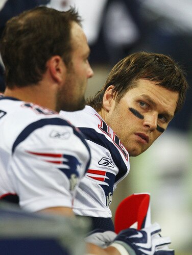 LONDON, ENGLAND - OCTOBER 25:  Tom Brady (#12) of the New England Patriots sits on the bench before the NFL International Series match between New England Patriots and Tampa Bay Buccaneers at Wembley Stadium on October 25, 2009 in London, England. This is the third occasion where a regular season NFL match has been played in London.  <br /><br /><span class="help">(Photo by Julian Finney/Getty Images)</span>
