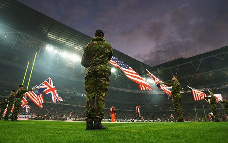 LONDON, ENGLAND - OCTOBER 25:  Soldiers hold up flags of the United Kingdom and United States of America before the NFL International Series match between New England Patriots and Tampa Bay Buccaneers at Wembley Stadium on October 25, 2009 in London, England. This is the third occasion where a regular season NFL match has been played in London.  <br /><br /><span class="help">(Photo by Julian Finney/Getty Images)</span>