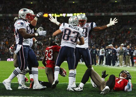 LONDON, ENGLAND - OCTOBER 25: Wes Welker (#83) of the New England Patriots is congratulated by his teamates after scoring the second touchdown during the NFL International Series match between New England Patriots and Tampa Bay Buccaneers at Wembley Stadium on October 25, 2009 in London, England. This is the third occasion where a regular season NFL match has been played in London.  <br /><br /><span class="help">(Photo by Tom Shaw/Getty Images)</span>