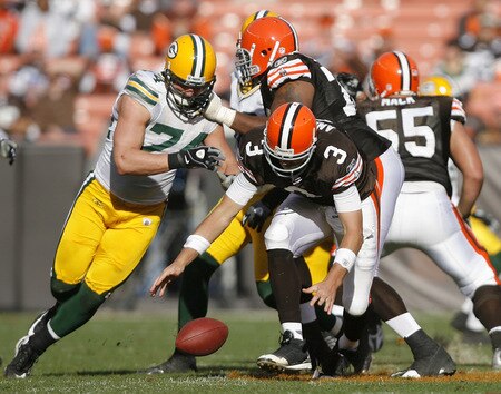 CLEVELAND, OH - OCTOBER 25:  Derek Anderson #3 of the Cleveland Browns fights for a fumble with Aaron Kampman #74 the Green Bay Packers at Cleveland Browns at Cleveland Browns Stadium on October 25, 2009 in Cleveland, Ohio.  <br /><br /><span class="help">(Photo by Matt Sullivan/Getty Images)</span>