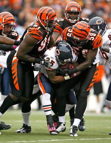 CINCINNATI - OCTOBER 25:  Garrett Wolfe #25 of the Chicago Bears is tackled by Robert Geathers #91 and Brandon Johnson #59 of the Cincinnati Bengals during the NFL game at Paul Brown Stadium on October 25, 2009 in Cincinnati, Ohio. The Bengals won 45-10.  <br /><br /><span class="help">(Photo by Andy Lyons/Getty Images)</span>