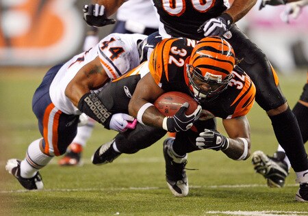 CINCINNATI - OCTOBER 25:  Cedric Benson #32 of the Cincinnati Bengals runs with the ball while defended by Kevin Payne #44 of the Chicago Bears during the NFL game at Paul Brown Stadium on October 25, 2009 in Cincinnati, Ohio.  The Bengals won 45-10.  <br /><br /><span class="help">(Photo by Andy Lyons/Getty Images)</span>