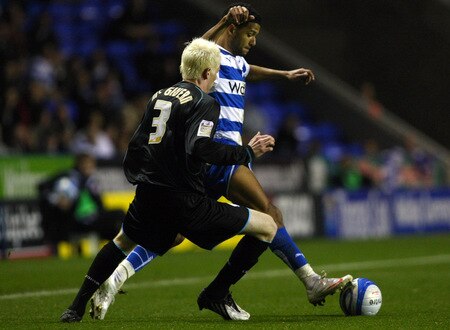 READING, ENGLAND - OCTOBER 26:  Jobi McAnuff of Reading is challenged by Ryan McGivern of Leicester City during the Coca-Cola Championship match between Reading and Leicester City on October 26, 2009 in Reading, England.  <br /><br /><span class="help">(Photo by Clive Rose/Getty Images)</span>