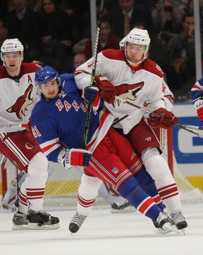 NEW YORK - OCTOBER 26: Enver Lisin #81 of the New York Rangers is hit by Martin Hanzal #11 of the Phoenix Coyotes on October 26, 2009 in New York, New York. <br /><br /><span class="help">(Photo by Bruce Bennett/Getty Images)</span>