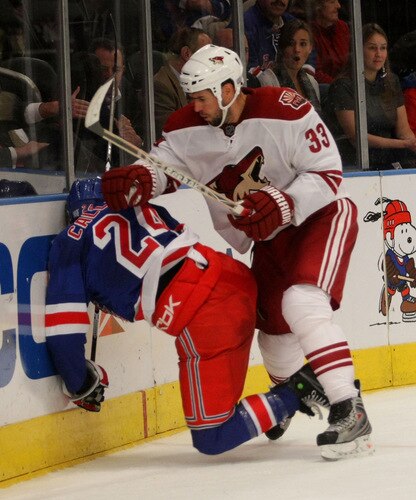 NEW YORK - OCTOBER 26:  Ryan Callahan #24 of the New York Rangers is hit into the boards by Adrian Aucoin #33 of the Phoenix Coyotes at Madison Square Garden on October 26, 2009 in New York City. The Rangers defeated the Coyotes 5-2. <br /><br /><span class="help">(Photo by Bruce Bennett/Getty Images)</span>