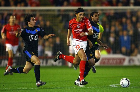 BARNSLEY, ENGLAND - OCTOBER 27:  Anderson of Barnsley beats Fabio Da Silva and Anderson of Manchester United during the Carling Cup 4th Round match between Barnsley and Manchester United at Oakwell on October 27, 2009 in Barnsley, England.  <br /><br /><span class="help">(Photo by Alex Livesey/Getty Images)</span>