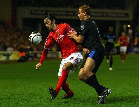 BARNSLEY, ENGLAND - OCTOBER 27:  Daniel Bogdanovic of Barnsley shields the ball under pressure from Wes Brown of Manchester United during the Carling Cup 4th Round match between Barnsley and Manchester United at Oakwell on October 27, 2009 in Barnsley, England.  <br /><br /><span class="help">(Photo by Alex Livesey/Getty Images)</span>