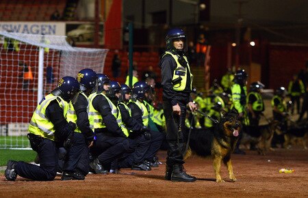 BARNSLEY, ENGLAND - OCTOBER 27:  Riot police line up in front of the Manchester United supporters during the Carling Cup 4th Round match between Barnsley and Manchester United at Oakwell on October 27, 2009 in Barnsley, England.  <br /><br /><span class="help">(Photo by Alex Livesey/Getty Images)</span>