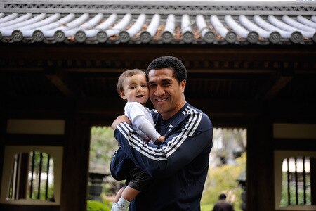 TOKYO - OCTOBER 28:  Mils Muliaina poses with his son Max in the Japanese garden at the team hotel prior to a New Zealand All Blacks training session at Chiba on October 28, 2009 in Funabashi, Japan.  <br /><br /><span class="help">(Photo by Ross Land/Getty Images)</span>