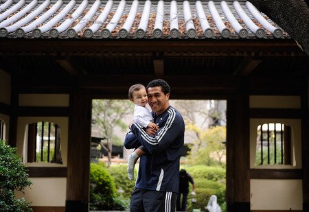 TOKYO - OCTOBER 28:  Mils Muliaina poses with his son Max in the Japanese garden at the team hotel prior to a New Zealand All Blacks training session at Chiba on October 28, 2009 in Funabashi, Japan.  <br /><br /><span class="help">(Photo by Ross Land/Getty Images)</span>
