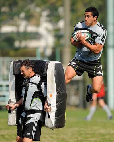 TOKYO - OCTOBER 28:  Mils Muliaina hits a padded bag held by assistant coach Wayne Smith (L) during a New Zealand All Blacks training session at Kubota Spears Rugby Field in Chiba on October 28, 2009 in Funabashi, Japan.  <br /><br /><span class="help">(Photo by Ross Land/Getty Images)</span>