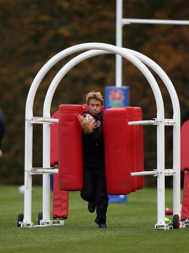 BAGSHOT, ENGLAND - OCTOBER 28:  Jonny Wilkinson, breaks through a tackle machine during the England training session held at Pennyhill Park on October 28, 2009 in Bagshot, England.  <br /><br /><span class="help">(Photo by David Rogers/Getty Images)</span>