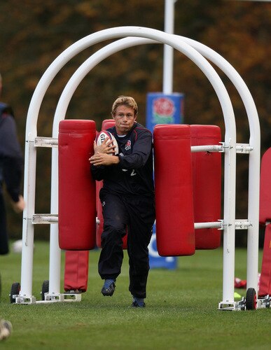 BAGSHOT, ENGLAND - OCTOBER 28: Jonny Wilkinson, breaks through a tackle machine during the England training session held at Pennyhill Park on October 28, 2009 in Bagshot, England.  <br /><br /><span class="help">(Photo by David Rogers/Getty Images)</span>
