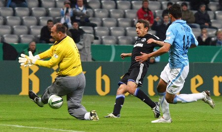 MUNICH, GERMANY - OCTOBER 28:  Rafinha (C) of Schalke scores his team's first goal against goalkeeper Gabor Kiraly (L) of 1860 and his team mate Jose Holebas (R) during the DFB Cup round of 16 match between 1860 Muenchen and FC Schalke 04 at Allianz Arena on October 28, 2009 in Munich, Germany.  <br /><br /><span class="help">(Photo by Alexander Hassenstein/Bongarts/Getty Images)</span>